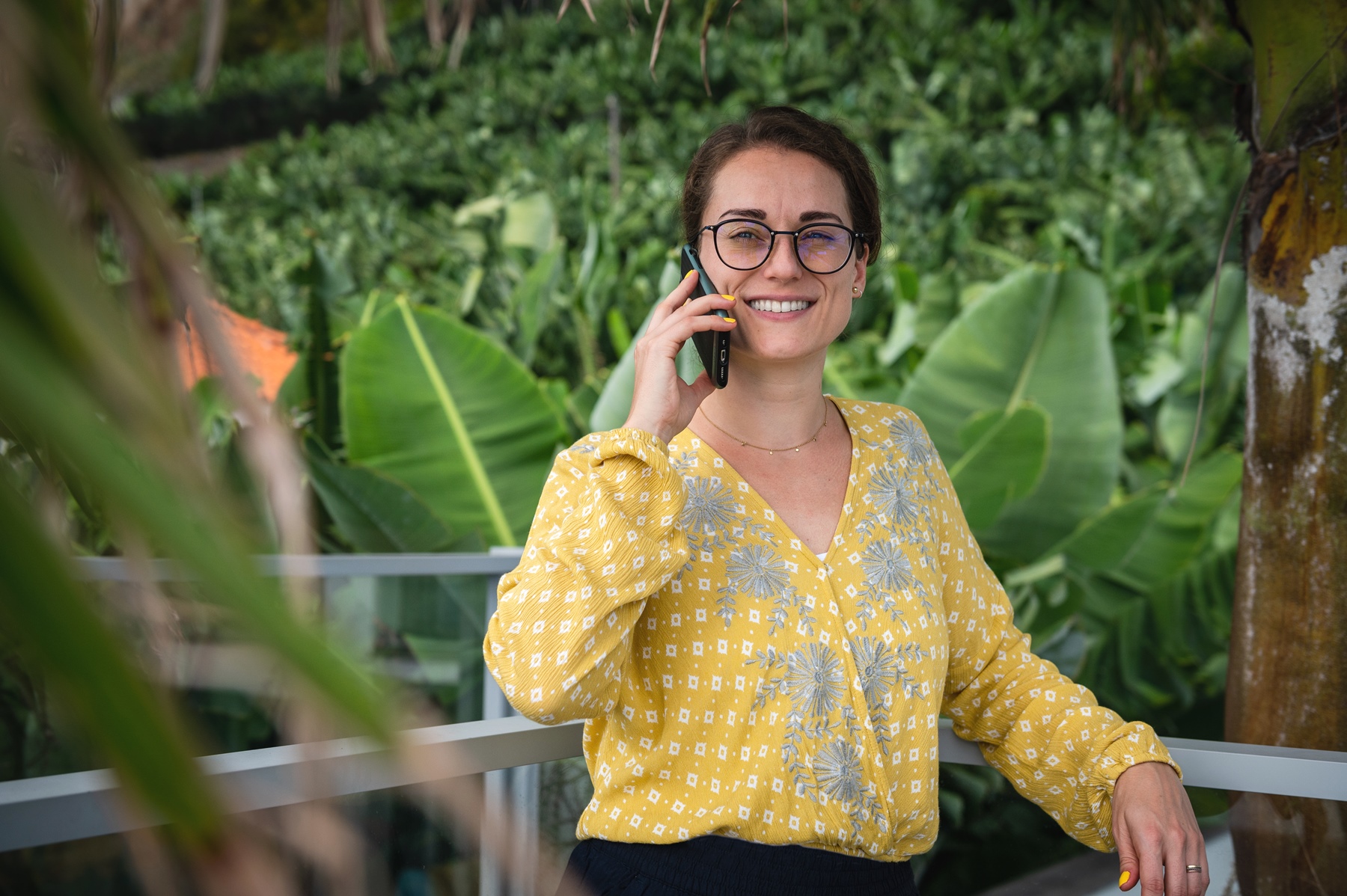 German travel content writer on her phone at a hotel